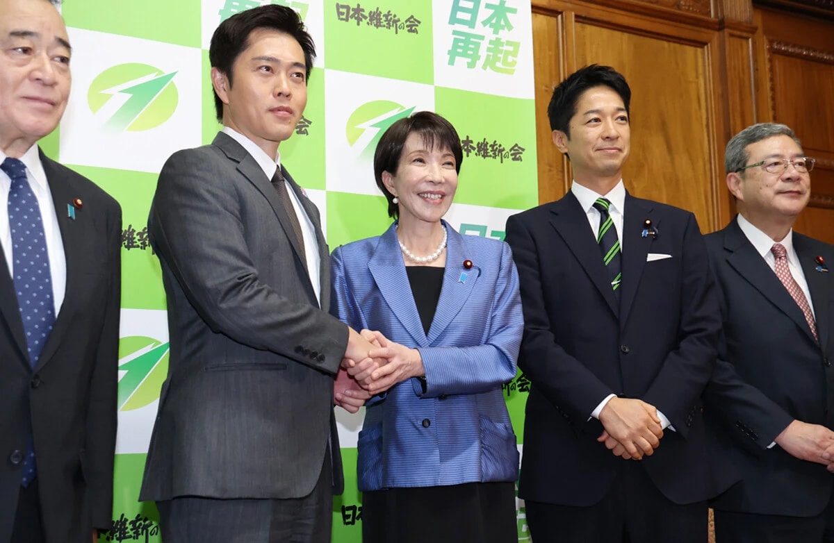 日本維新の会の吉村洋文代表(左から2人目)と握手する自民党の高市早苗総裁(中央)