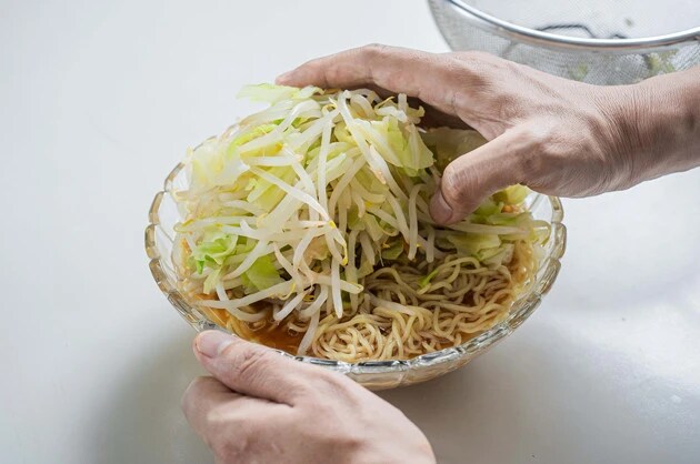 （３）盛る！　スープの用意ができたら丼に麺を入れ、野菜を山のように盛れば完成。オススメトッピングは焼き豚と焦がしにんにく。冷やし中華よりもラーメンに合う具材を選ぶのがポイント